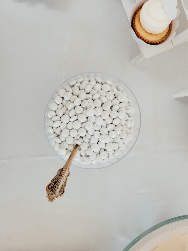 White M&Ms on a dessert table at a cloud themed baby shower