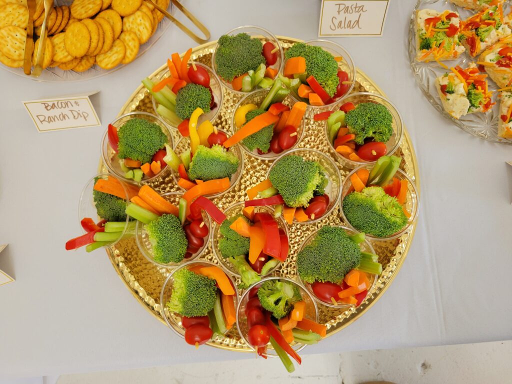 veggie cups on a food table at a cloud themed baby shower