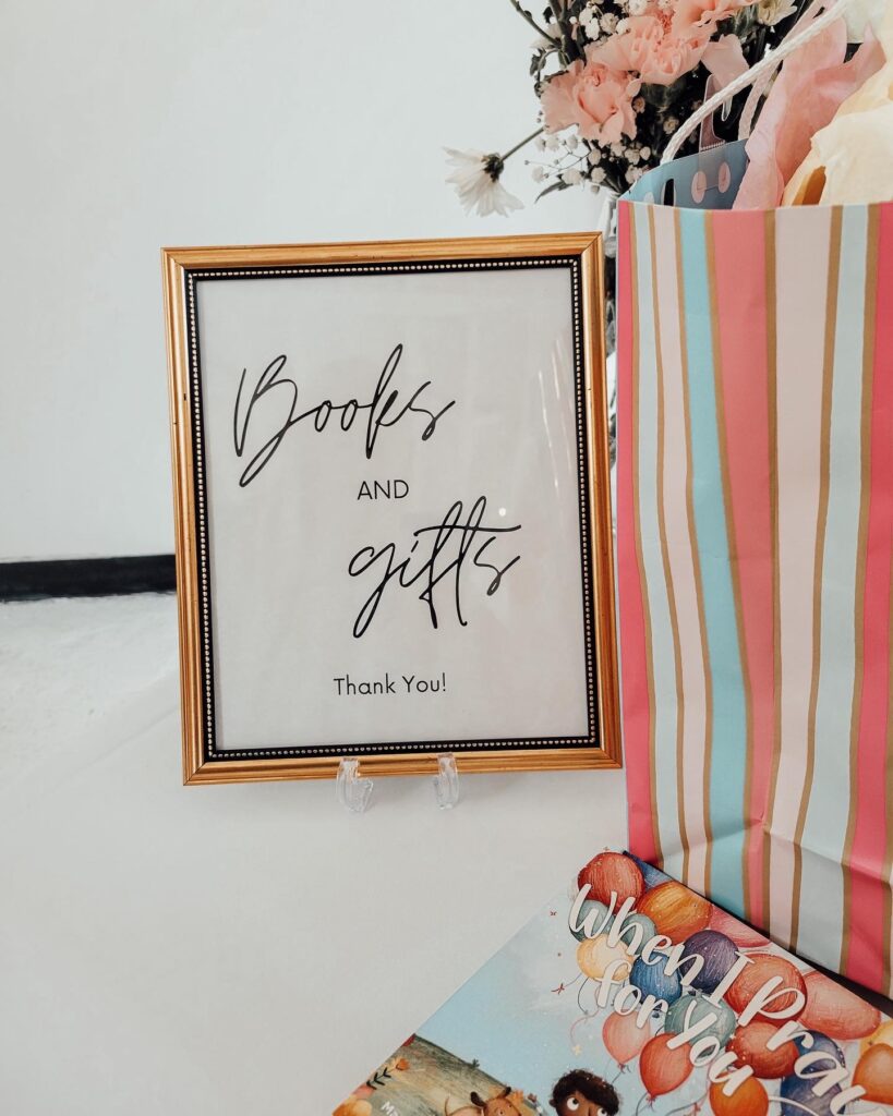 Books and gifts sign for a table at a cloud themed baby shower