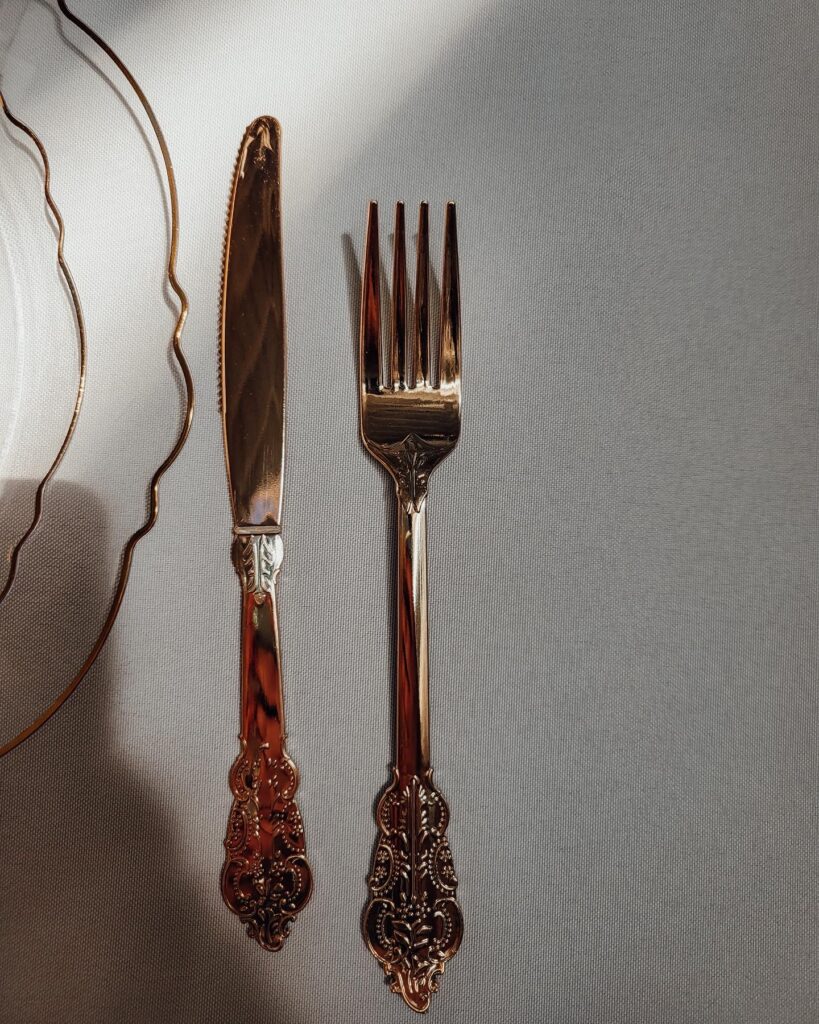 gold fork and knife place setting at a cloud themed baby shower