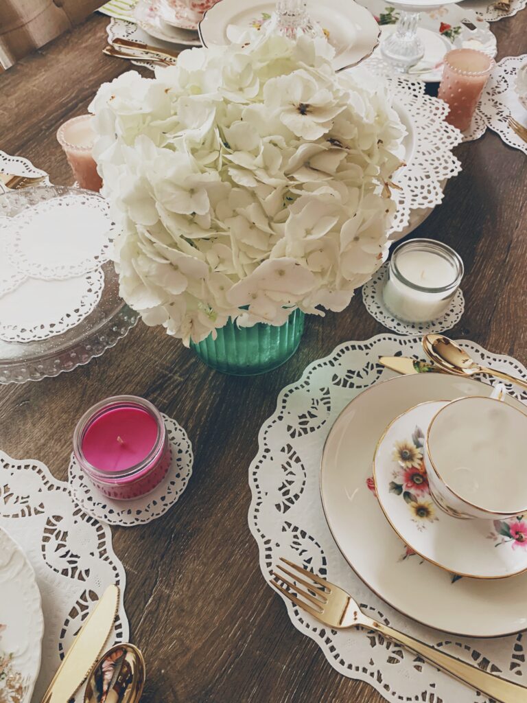 beautiful white hydrangea flower arrangement on a table with tea sets
