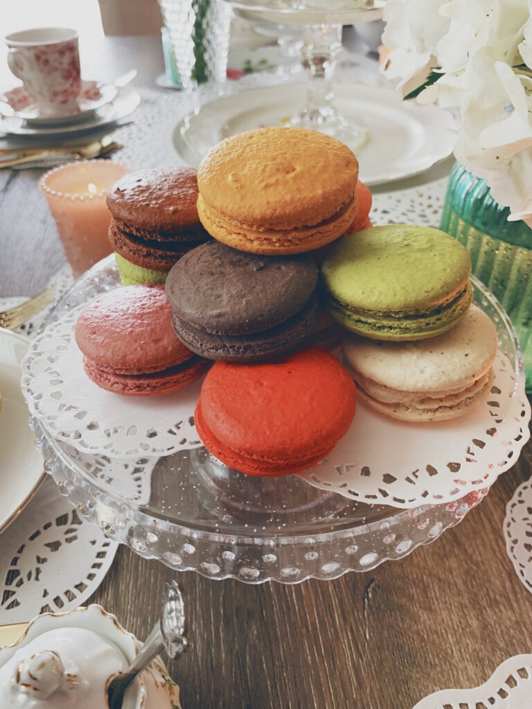 colorful macarons on a small cake tier
