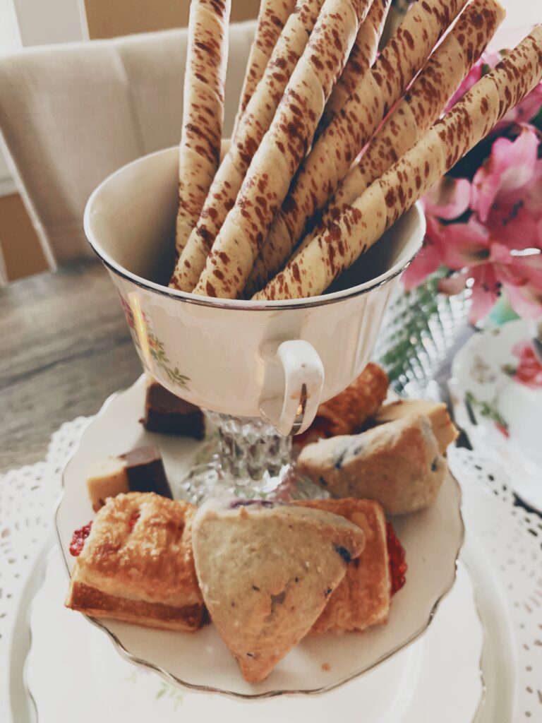 delicious tea party finger foods and scones placed on a vintage food tier display