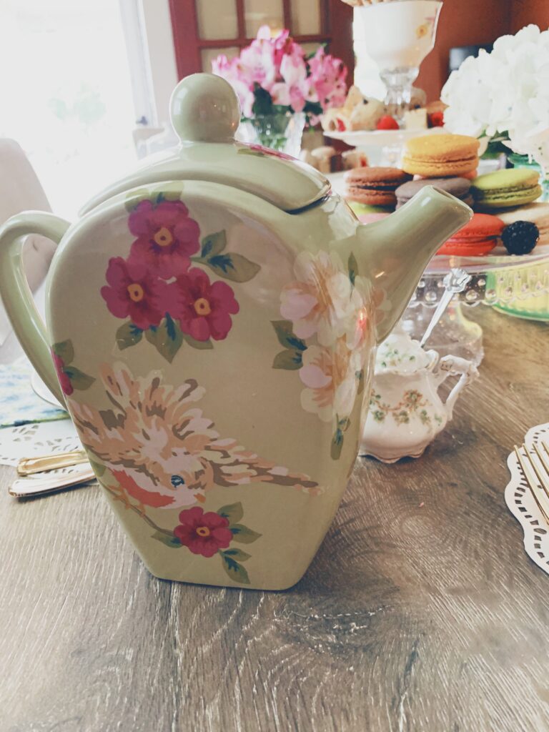 beautiful, vintage tea pitcher placed on a table spread for a tea party themed brunch