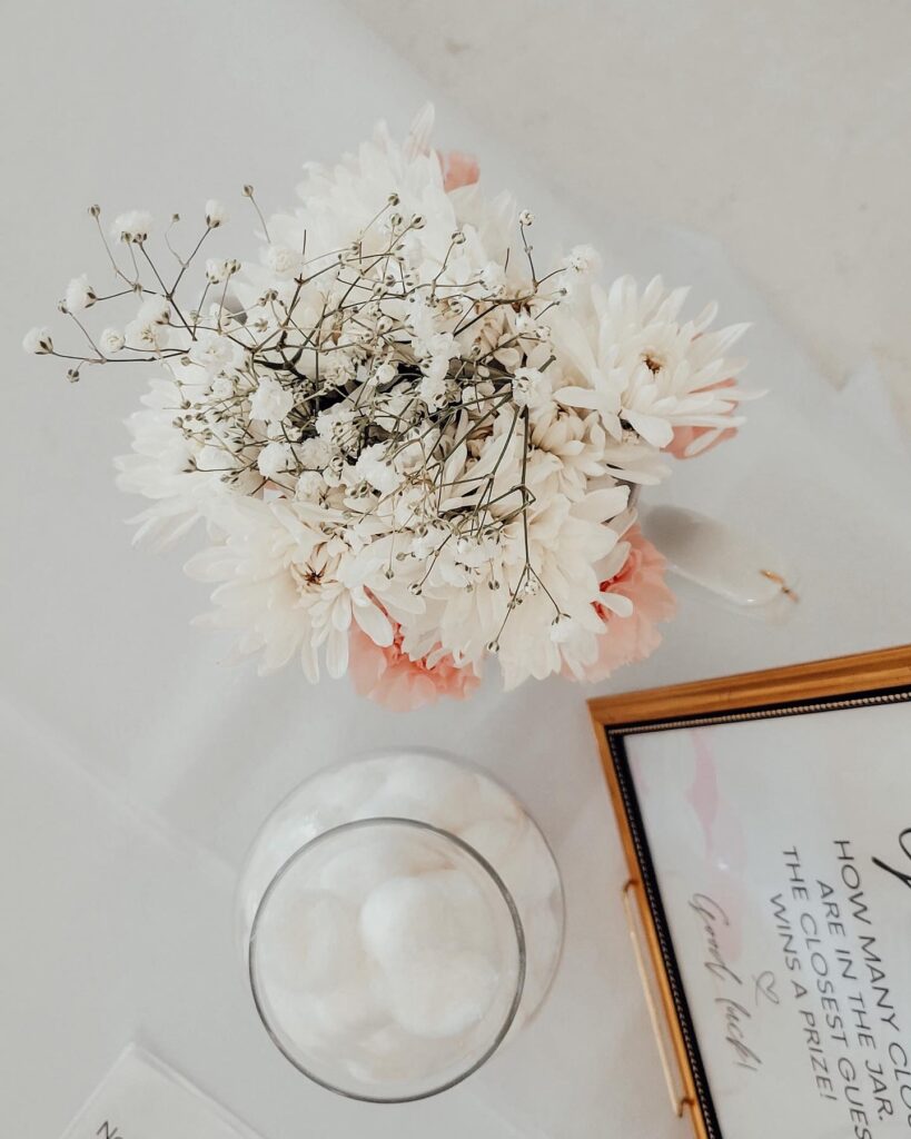 vase of white and pink flowers with pink flowers for a cloud themed baby shower