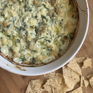 a homemade bowl of spinach artichoke dip appetizer for a party or tailgate.