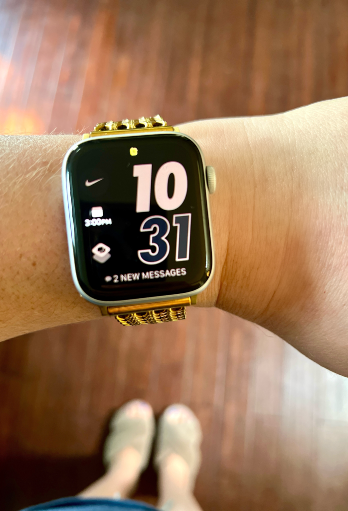 Apple smart watch with gold band to help with productivity and organization hacks for working moms