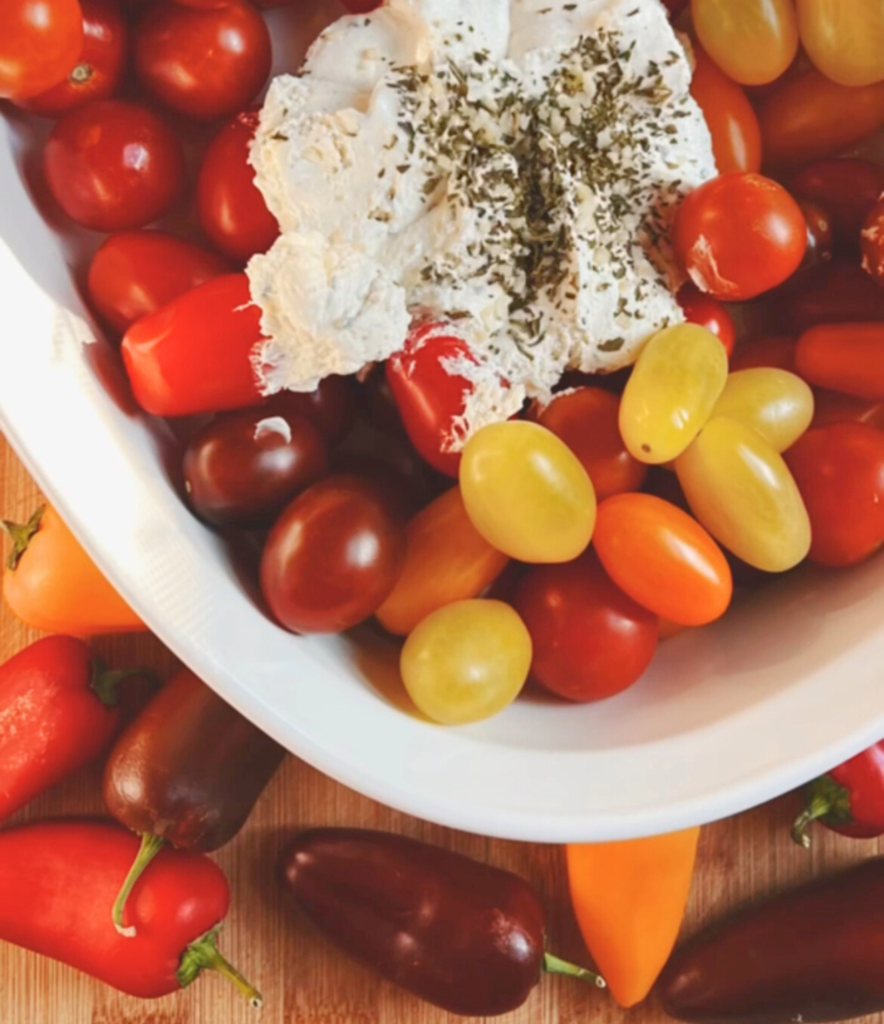 tomatoes and cheese in baking dish ready to roast so we can make creamy roasted tomato soup