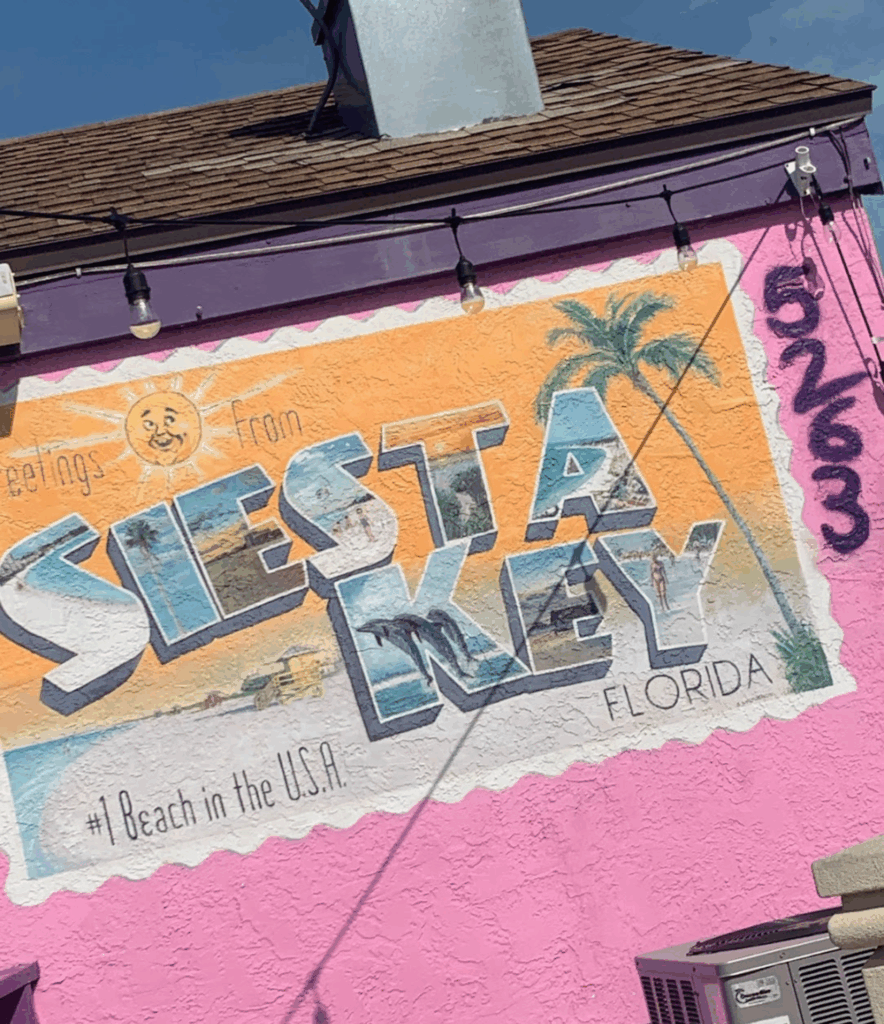 Postcard on side of building for Siesta Key Travel Guide blog post