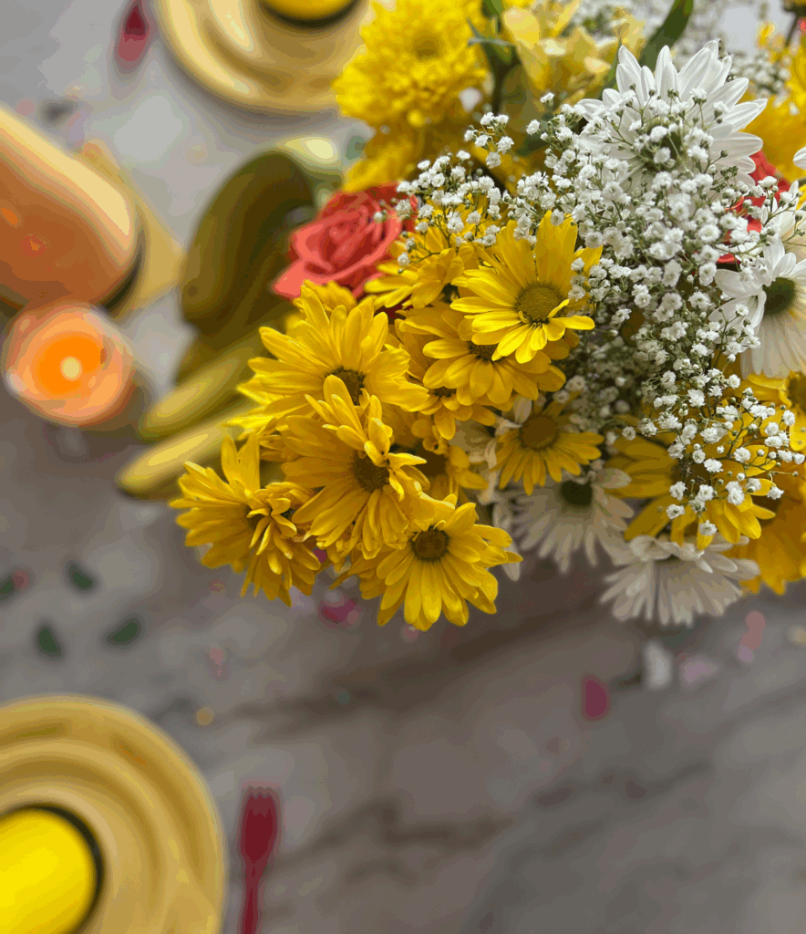 Yellow flowers on a table for Curious George birthday party