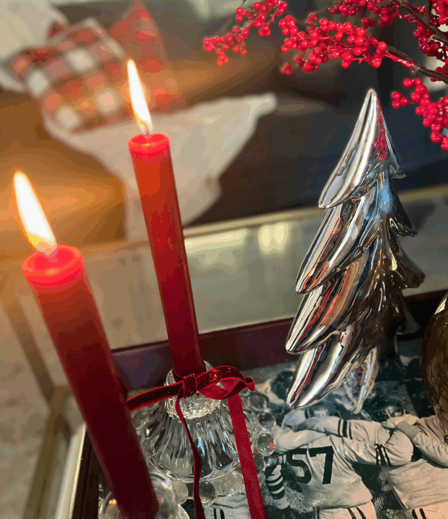 Coffee table Christmas decor with bows, candlesticks and holiday floral for a blog post about the Ralph Lauren Christmas trend.