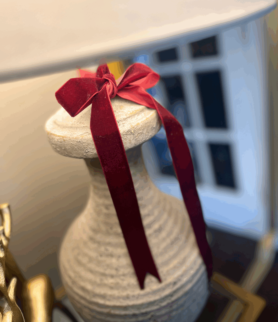 Velvet burgundy ribbon tied around a lamp for a blog post about the Ralph Lauren Christmas trend.