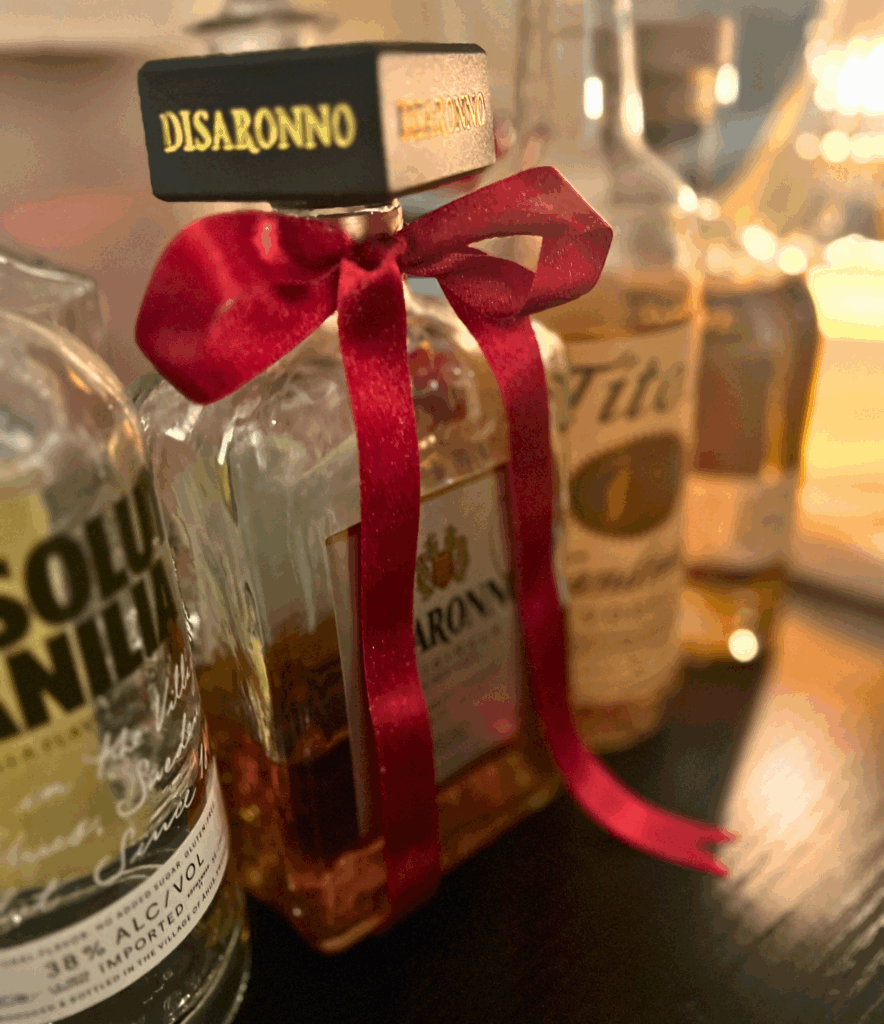 Burgundy bow tied around a liquor bottle for a blog talking about the Ralph Lauren Christmas trend.