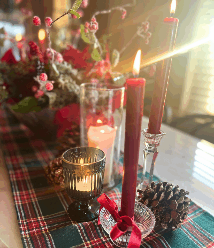 Burgundy candlesticks in crystal holders with bows tied around them capturing the essence of the Ralph Lauren Christmas trend