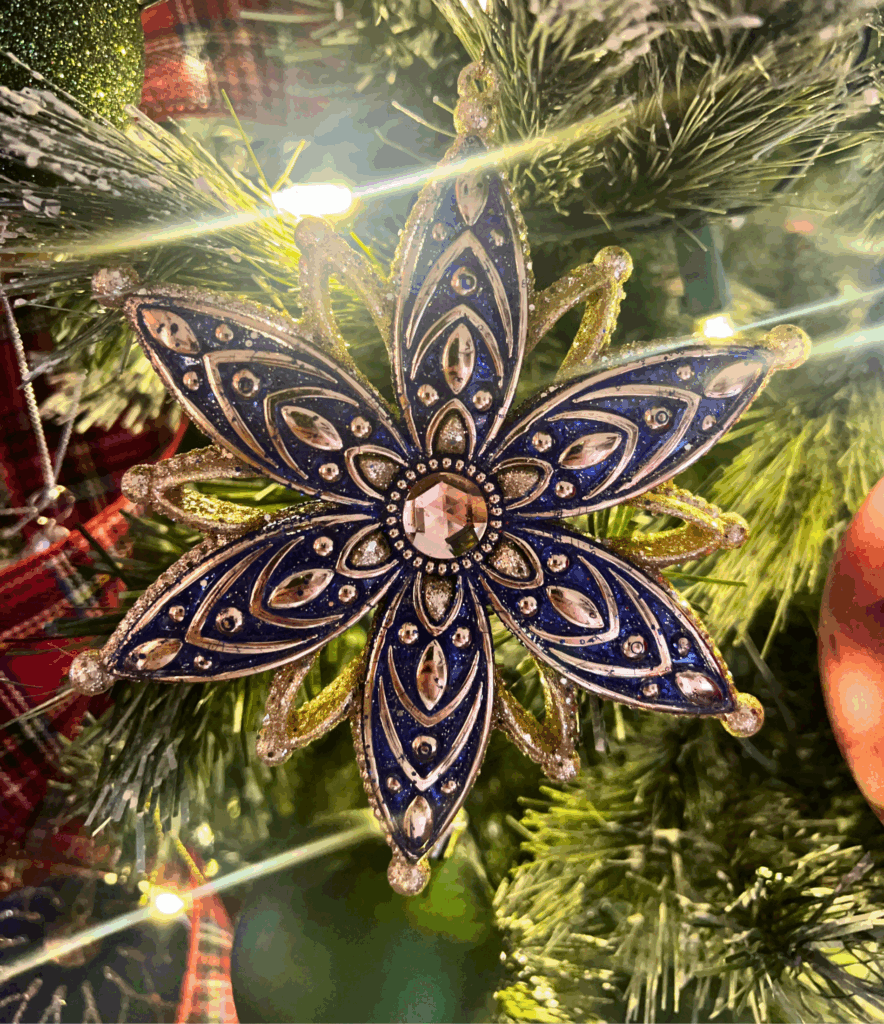 Ornate blue and gold christmas tree ornament for a blog post about the Ralph Lauren Christmas trend.