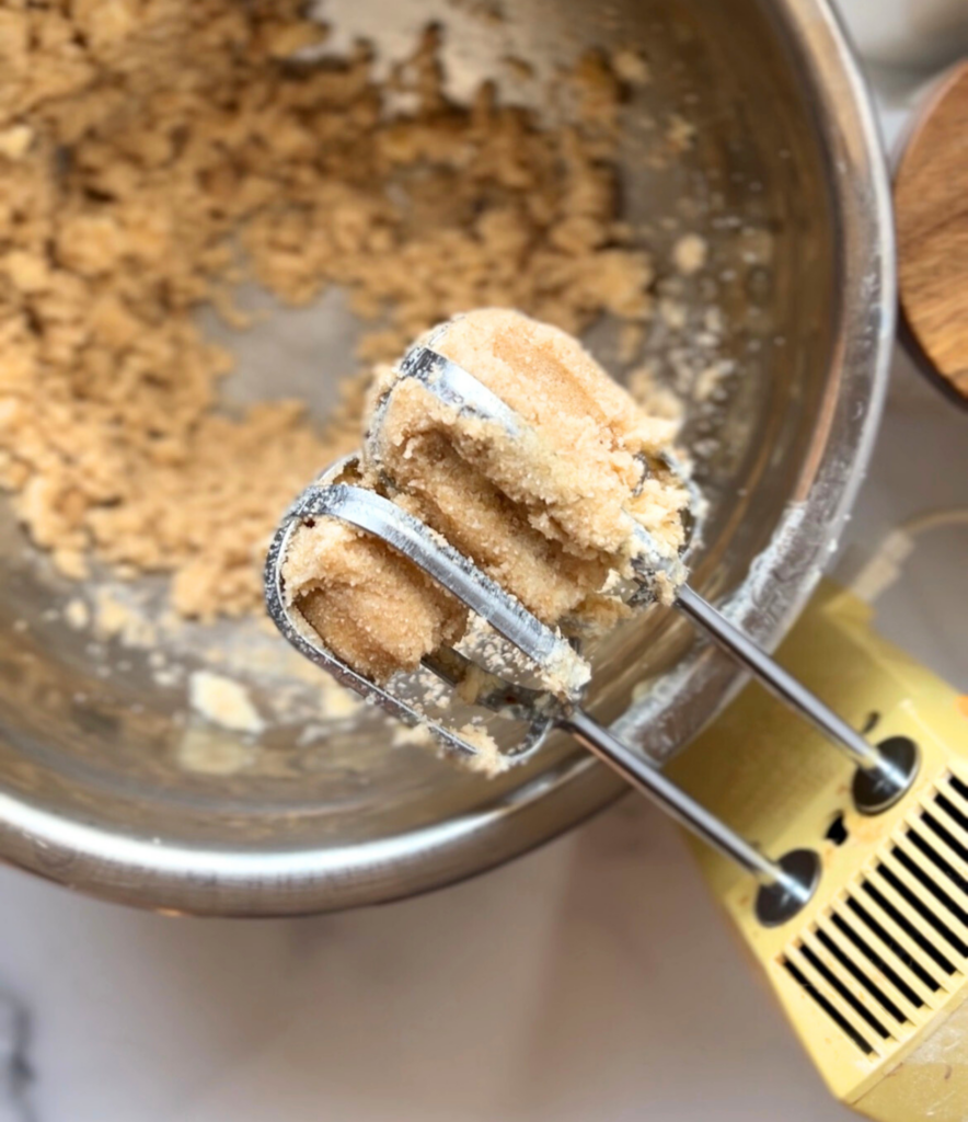 Chocolate chip cookie cake batter in a mixing bowl before baking