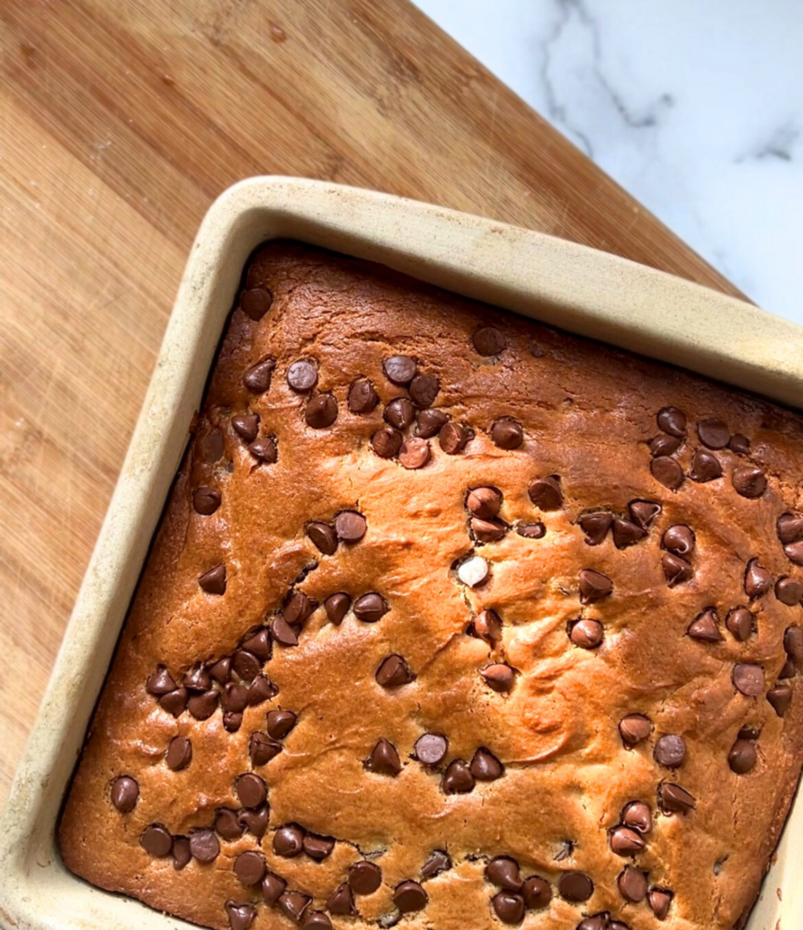 Top-down view of homemade chocolate chip cookie cake sliced and ready to serve