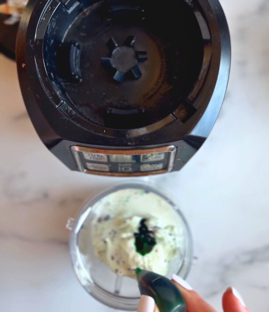 Adding ingredients to a blender for a copycat shamrock shake