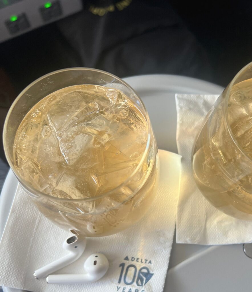 glass of champagne on a flight to mexico, solo travel for women