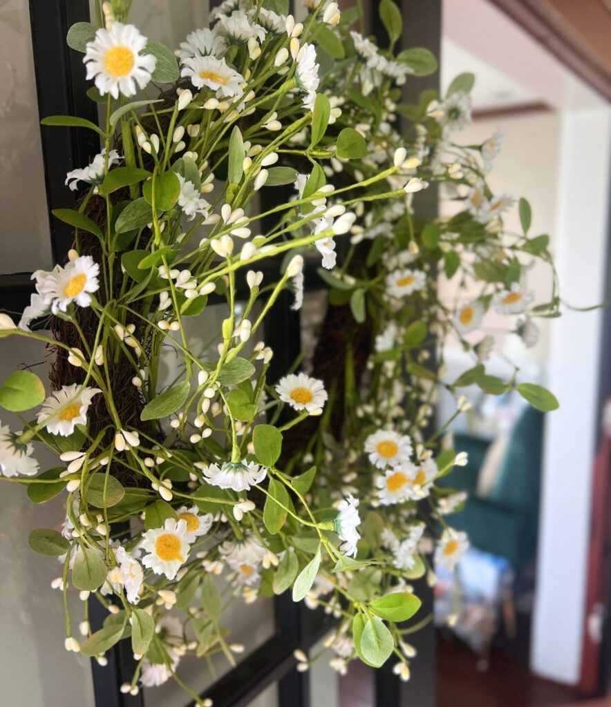 simple spring decor wreath in an entryway
