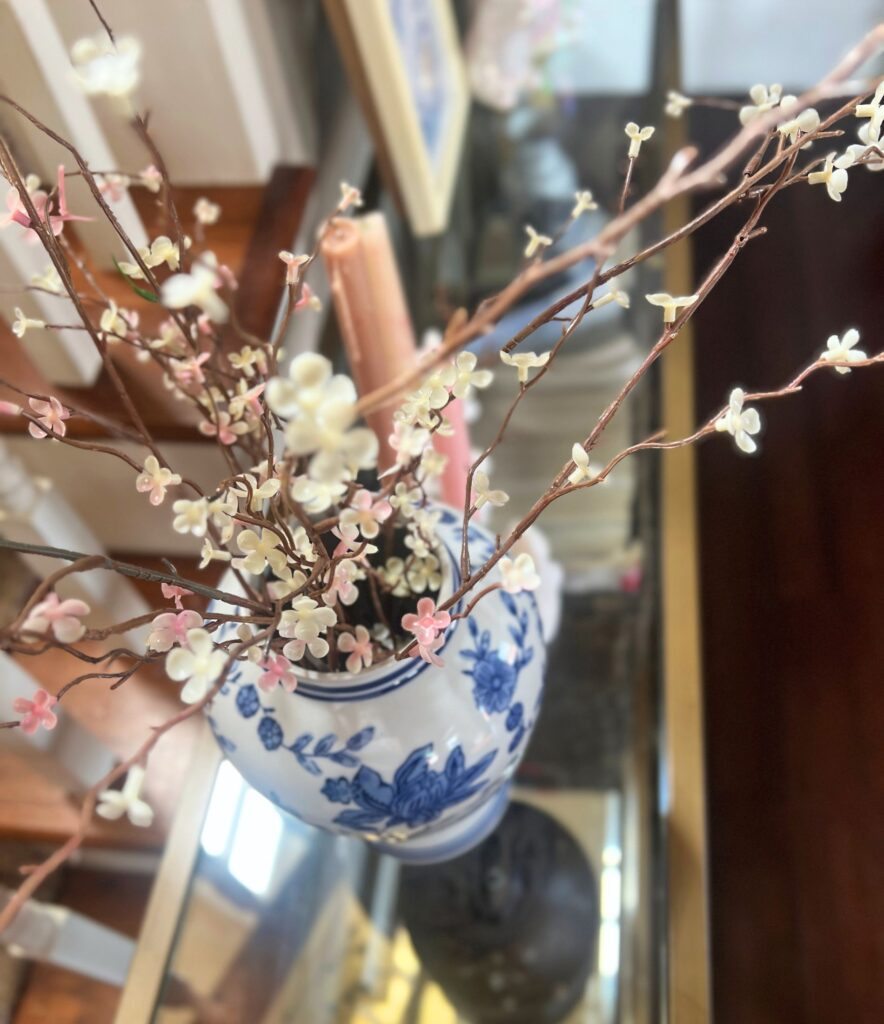 simple spring decor in an entryway with soft neutral tones and light seasonal accents