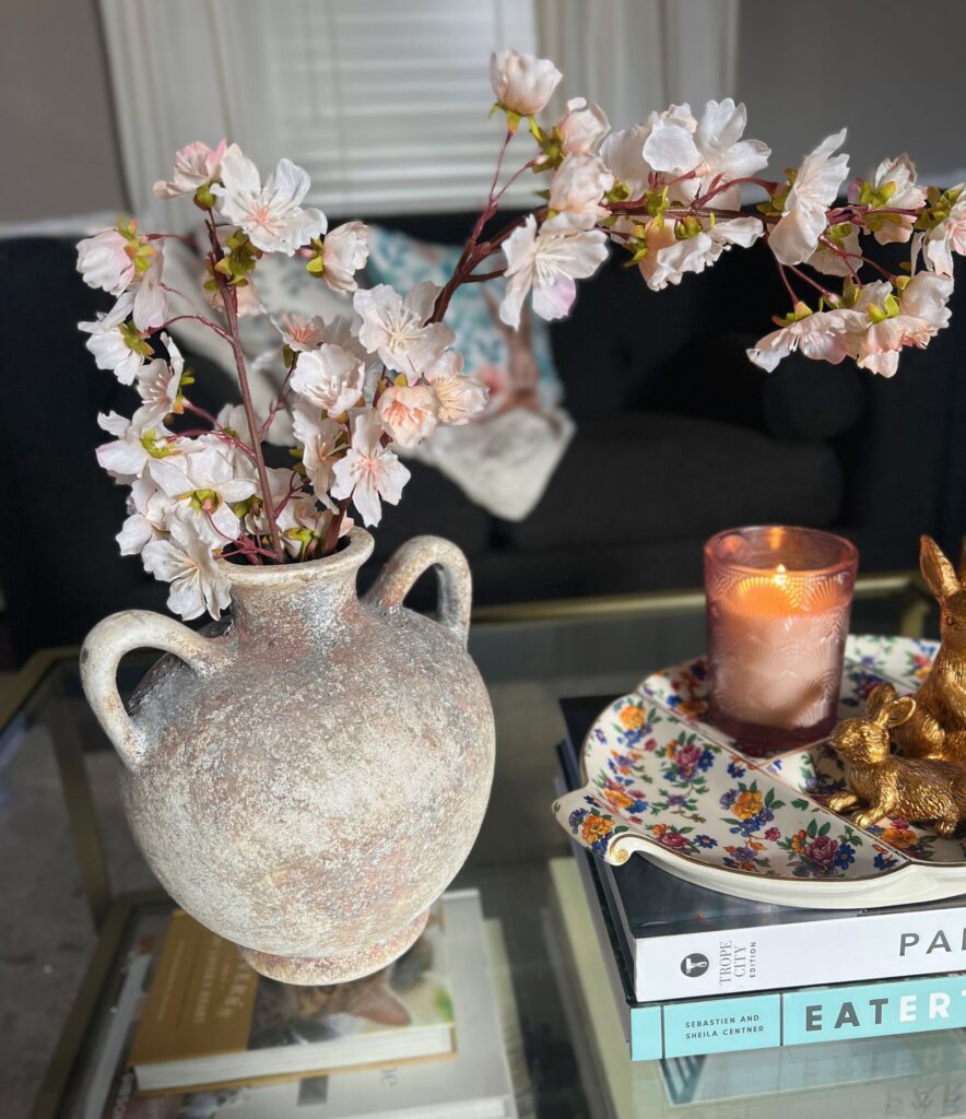 simple spring decor with budding florals in a travertine vase