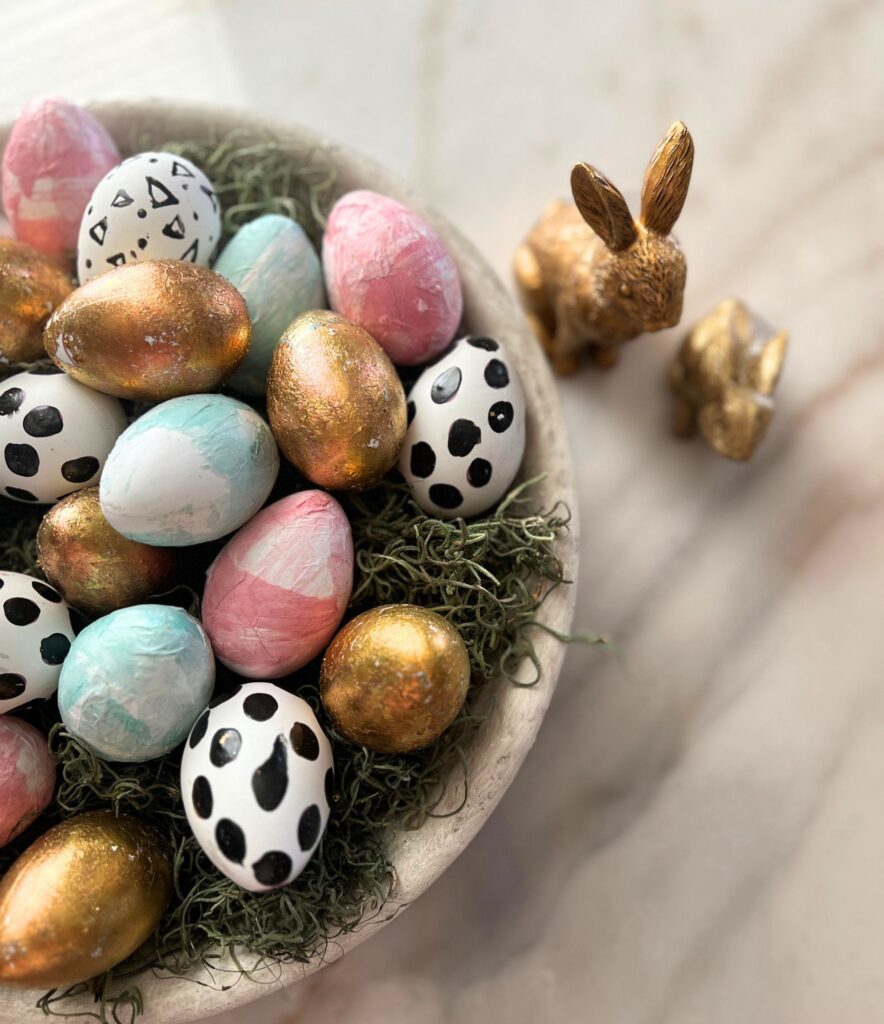 simple spring decor with colorful Easter eggs styled in a travertine bowl on a marble dining table